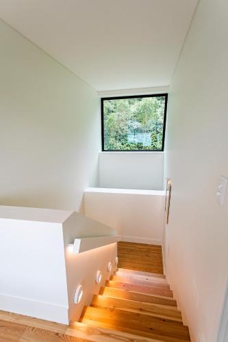 a staircase in a house with a window at Sete Cidades Lake Cabin - Casa da Lagoa in Ponta Delgada