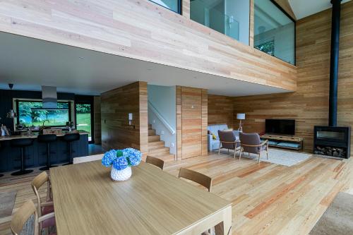 a room with a table with a vase of flowers on it at Sete Cidades Lake Cabin - Casa da Lagoa in Ponta Delgada