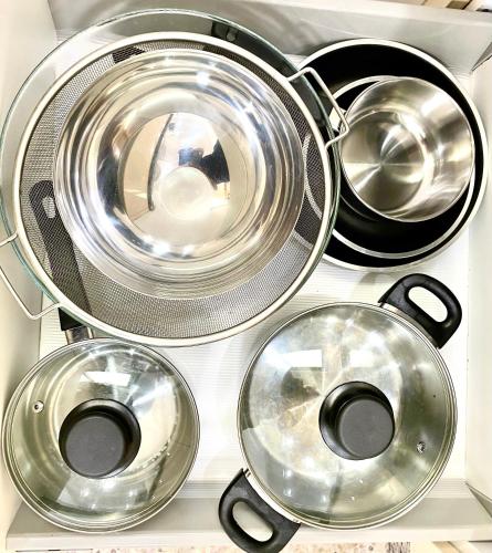 a bunch of pots and pans in a drawer at Résidence Bario H in Al Hoceïma