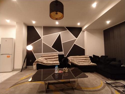 a living room with a black couch and a table at Black Pearl Luxury Apartments in Blackpool