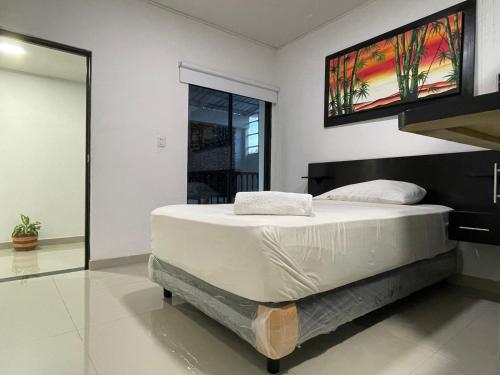 a bedroom with a bed with a tv on the wall at Hotel Boutique La Riviera in Rivera