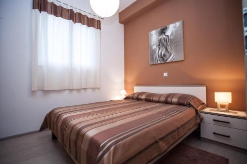 a bedroom with a large bed and a window at Apartments Nenich Aves in Žman