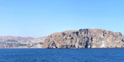 a large mountain in the middle of a body of water at Résidence Bario H in Al Hoceïma