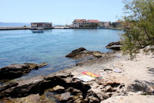 a body of water with rocks and a boat in it at Rooms by the sea Sucuraj, Hvar - 6734 in Sućuraj