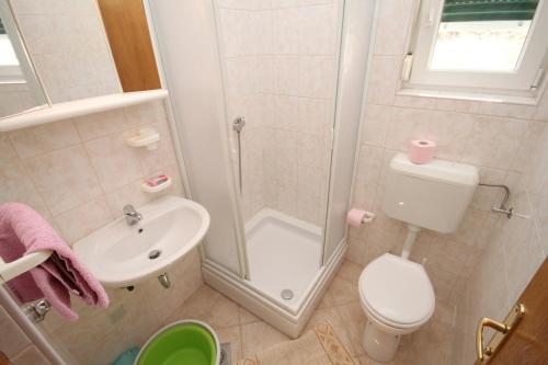 a bathroom with a shower and a toilet and a sink at Apartments with a parking space Kozjaca, Paklenica - 6565 in Šibuljina