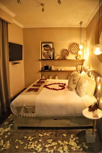 a hotel room with a bed and a television at Agata Hotel Boutique & Spa in Mexico City