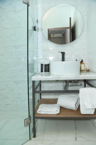 a bathroom with a sink and a mirror at Agata Hotel Boutique & Spa in Mexico City