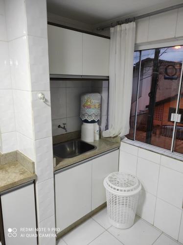 a small kitchen with a sink and a window at APARTAMENTO DE PRAIA in Florianópolis