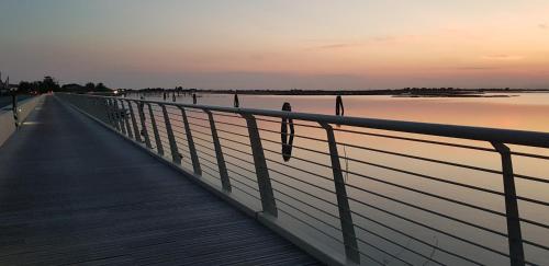 a bridge over a body of water at sunset at Casa Lola in Cavallino-Treporti
