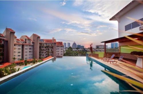 a large swimming pool on top of a building at Peninsula Residences All Suite Hotel in Kuala Lumpur