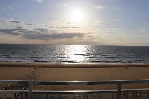 a view of the ocean from a balcony of a beach at Oceanfront beach, sky, & dolphins in Virginia Beach