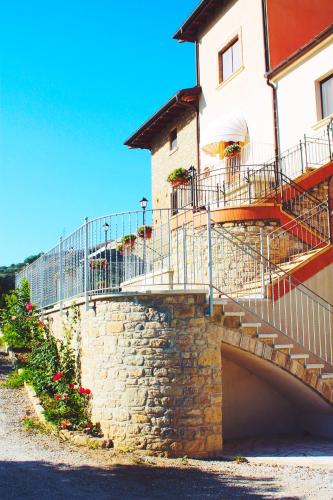 a building with stairs and flowers in front of it at Agriturismo U' Casinu dà Scala in Campora San Giovanni