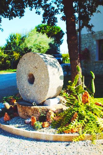 a rock statue sitting on the side of a street at Agriturismo U' Casinu dà Scala in Campora San Giovanni