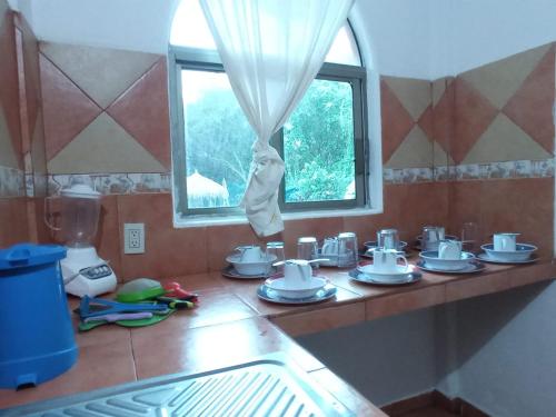 a kitchen counter with pots and pans on it at Manglar Pacific in Los Ayala