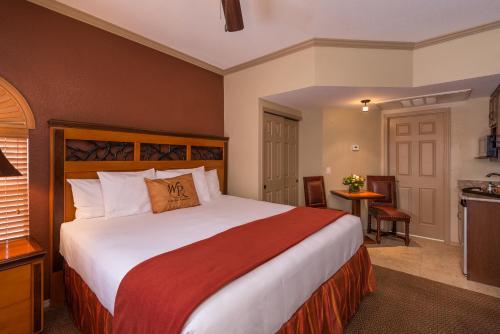 a bedroom with a large bed and a kitchen at Westgate Painted Mountain Golf Resort in Mesa