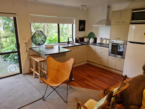 a kitchen with a table and chairs in a room at Five paddocks Tamahere in Tamahere