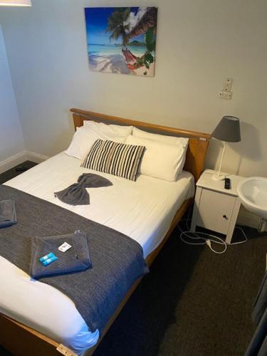 a hotel room with a bed and a sink at Cornwall Hotel in Moonta