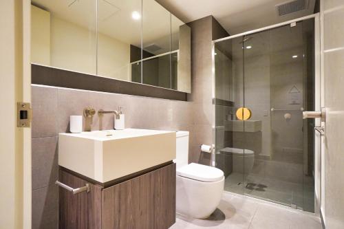 a bathroom with a sink and a toilet and a shower at Luxury City Zen Apartment Rundle Mall with Rooftop Spa, Gym, BBQ in Adelaide