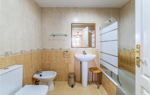 a bathroom with a sink and a toilet and a mirror at 1 Bedroom Gorgeous Apartment In Roquetas De Mar in Roquetas de Mar
