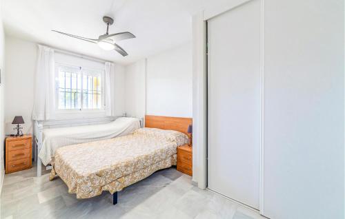 a white bedroom with a bed and a window at 1 Bedroom Gorgeous Apartment In Roquetas De Mar in Roquetas de Mar