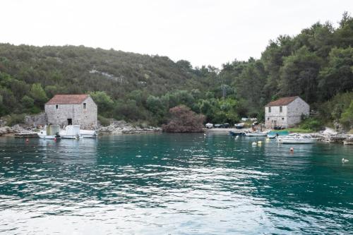 a body of water with houses and boats in it at Apartments with a parking space Rudina, Hvar - 13903 in Stari Grad