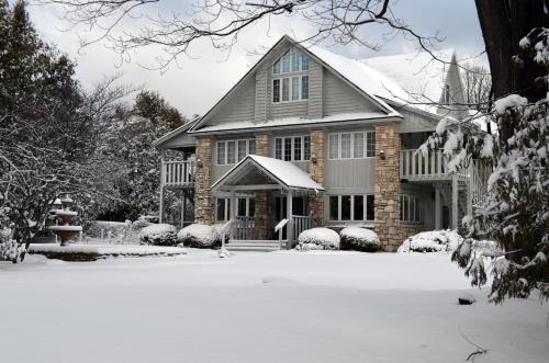 a house with snow on the ground in front of it at Country House Resort in Sister Bay