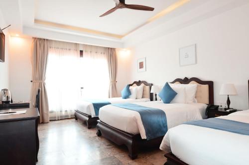 Katil atau katil-katil dalam bilik di Hoian Central Hotel