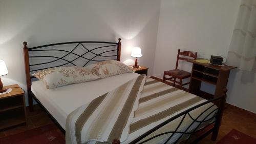 a bedroom with a bed and a table and a chair at Apartments by the sea Slatine, Ciovo - 4844 in Slatine