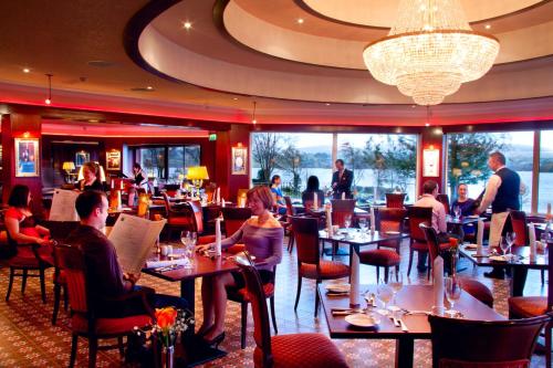 a dining room with people sitting at tables in a restaurant at Harvey's Point in Donegal