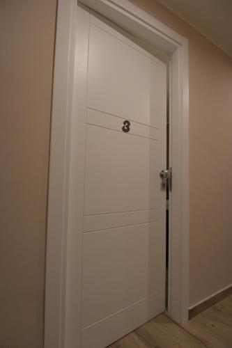 a white door with a silver handle in a room at ALMA B&B Home Cosenza in Cosenza