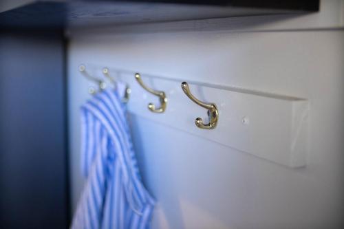 a closet with two hangers on a white wall at Arts Factory by Nomads in Byron Bay