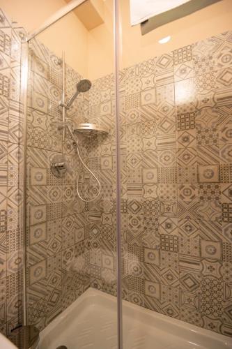 a bathroom with a shower with a glass door at ALMA B&B Home Cosenza in Cosenza