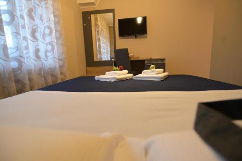 a room with a bed with towels on it at ALMA B&B Home Cosenza in Cosenza