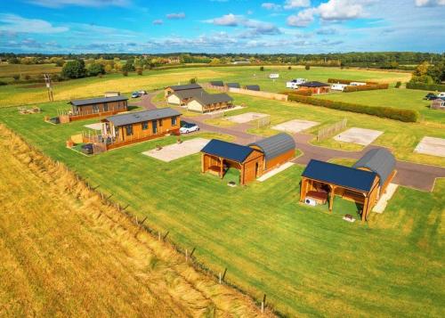 an aerial view of a farm with buildings in a field at Bowbrook Lodges in Pershore