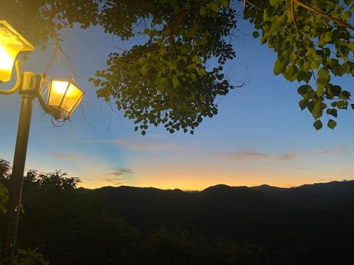 a street light with the sunset in the mountains at Kirinosato Takahara in Tanabe