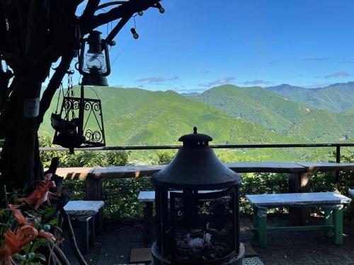 a lantern sitting on a patio with a view of mountains at Kirinosato Takahara in Tanabe