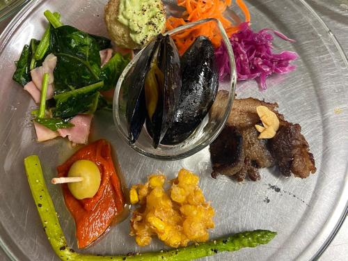 a plate of food with vegetables on a table at Kirinosato Takahara in Tanabe