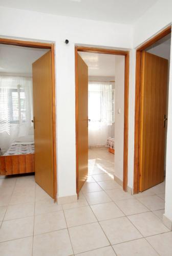 a hallway with two doors and a room with a bed at Seaside secluded apartments Cove Torac, Hvar - 4875 in Gdinj