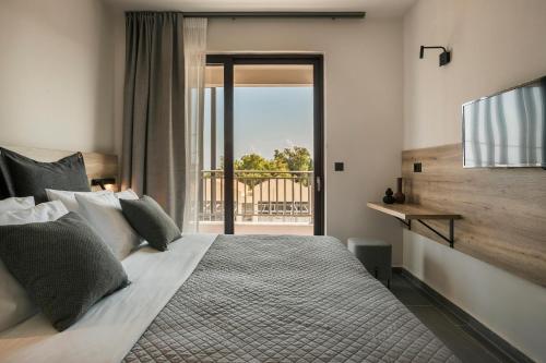 a bedroom with a large bed with a view at Skala Hotel in Skala