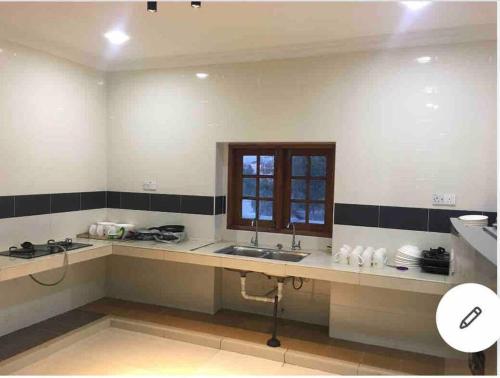 a kitchen with a sink and a window at Nilai Spring Villas in Nilai