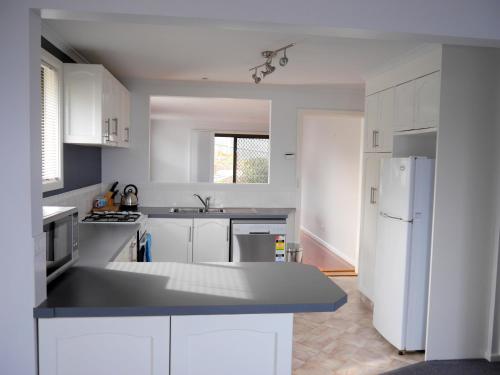 A kitchen or kitchenette at The Beach Escape