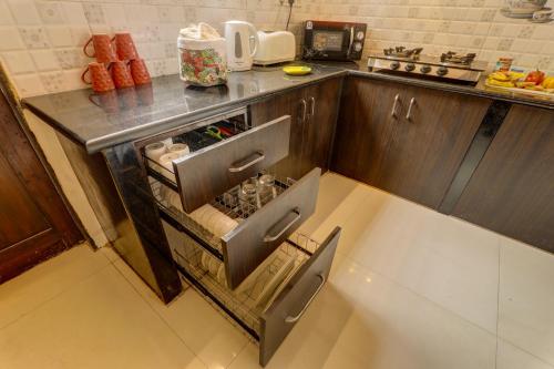 an open refrigerator in a kitchen with a counter at Ludo Private Pool Villa, WiFi-Caretaker-Parking, North Goa in Baga