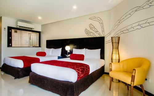A bed or beds in a room at Tanoa Waterfront Hotel