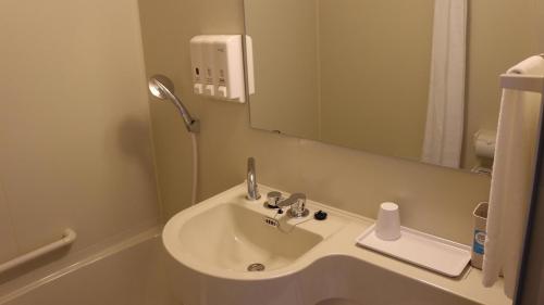 a bathroom with a sink and a mirror at Toyoko Inn Saga Ekimae in Saga