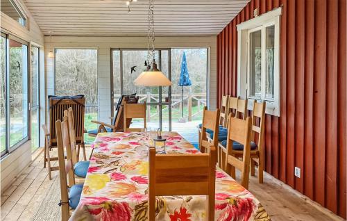 a dining room with a table and chairs at Gorgeous Home In Markaryd in Hässlehult