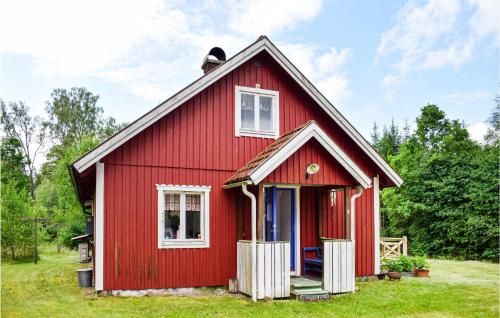a red house with a white door and windows at Gorgeous Home In Markaryd in Hässlehult