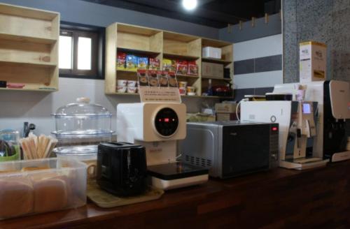 a kitchen with a counter with a clock on it at Java Hotel in Gwangyang