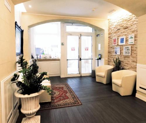 an office lobby with a large window and a plant at Hotel Patavium in Padova