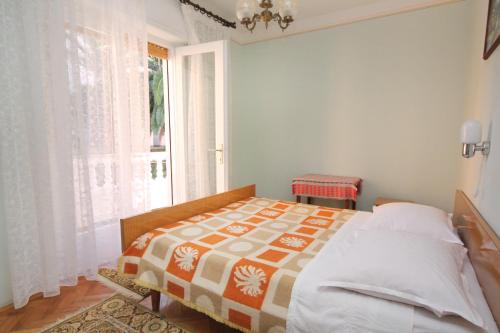 una camera con un letto e una grande finestra di Apartment Palit 5061a a Rab