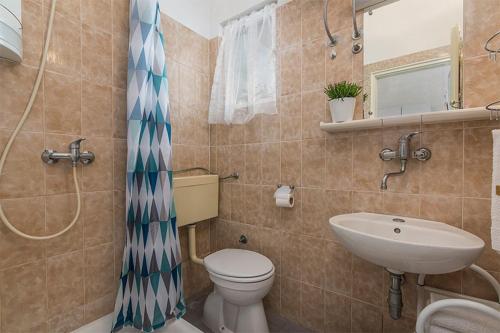 a bathroom with a toilet and a sink at Studio Novigrad 2536a in Novigrad Istria